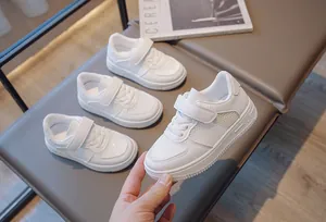Close-up showing detail of breathable white mesh sneakers for kids with velcro strap