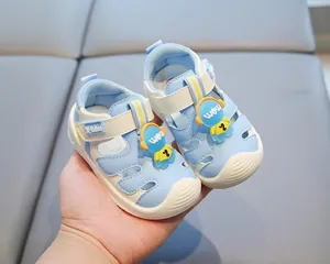 Detailed view of sky blue baby sandals with cute astronaut decorations and soft sole.
