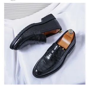 Detailed close-up view of black men's leather loafers with embossed crocodile skin texture