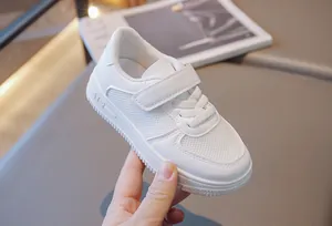 Detailed view of white breathable mesh sneakers for children with velcro strap