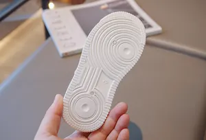 Close-up of white rubber sole for children's sneakers with anti-slip pattern