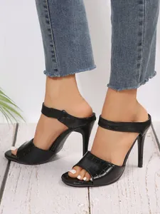 Sexy black crocodile pattern stiletto mules with open toe and high heels.