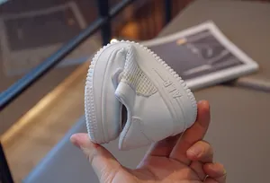 Close-up of flexible white children's sneaker sole showing high durability and breathability
