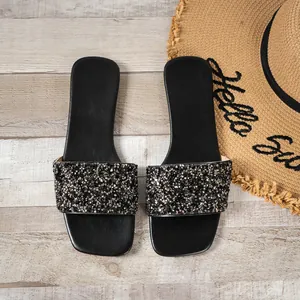Top view of black flat slide sandals featuring dense sparkling sequin and rhinestone straps