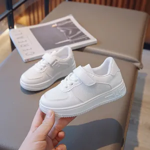 Breathable white children's sneakers with mesh panels and velcro straps for school kids