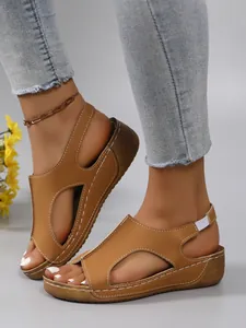 Stylish casual women's brown wedge sandals featuring hollow-out design and thick soles