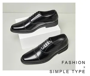 Detailed view of black genuine leather Oxford shoes for men with classic cap toe design.