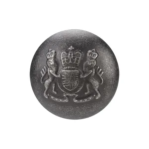 Antique brass button featuring an embossed royal heraldic lion and crown design on white background