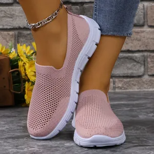 Primo piano di mocassini in mesh rosa traspirante da donna con suola bianca comoda