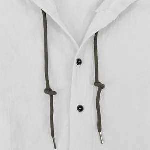 Close-up detail of a white linen-cotton hooded shirt featuring dark drawstrings and buttons.