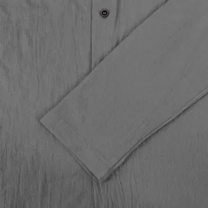 Detailed macro view of gray cotton linen men's shirt showing fabric texture and sleeve cuff