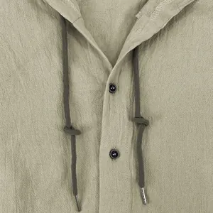 Close-up of men's cotton linen hooded shirt with drawstring and textured button details
