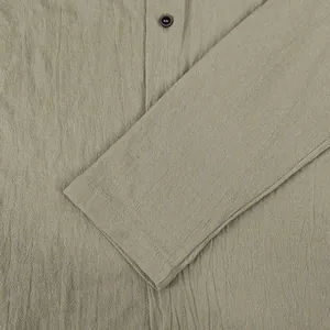 Close-up detail showing the crinkled cotton-linen fabric texture of a men's casual shirt.