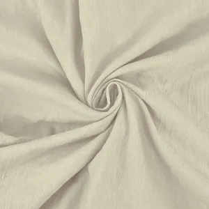 Macro detail view of beige cotton linen fabric showing the natural texture and breathable weave