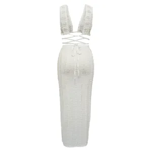 Back view of white textured lace two-piece set with lace-up crop top and long skirt