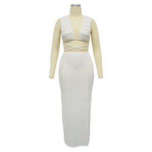 White lace two-piece set featuring a cropped tie-back top and high-waist maxi skirt.