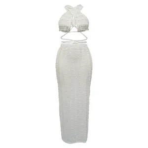Detailed view of white textured lace two-piece set with halter crop top and maxi skirt