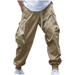 Close-up of khaki multi-pocket cargo pants with drawstring waist and elastic cuffs
