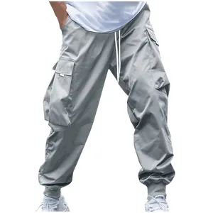 Detail shot of gray multi-pocket cargo joggers with white drawstring and elastic cuffs.