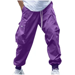 Front view detail of purple cargo pants showing large side pockets and drawstring.