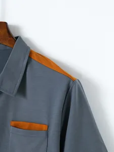 Close-up of men's grey polo shirt showing shoulder and pocket color block detail