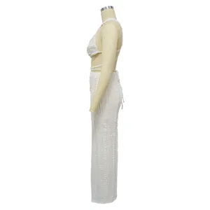 Side profile detail of white textured lace two-piece set with backless top and maxi skirt