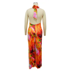 Vibrant abstract floral print halter backless wide-leg jumpsuit back view on mannequin