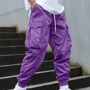 Detailed view of purple multi-pocket cargo pants with a loose fit and streetwear style.