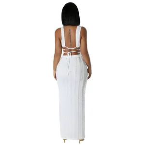 Back view of a white lace sleeveless backless maxi dress with delicate tie-up detail