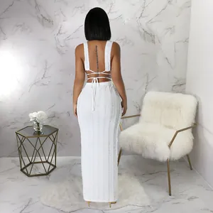 Detailed back view of white sleeveless lace maxi dress set with elegant tie-back design.