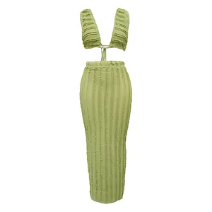 Detail view of green textured ruched two-piece set with tie-back top and maxi skirt.