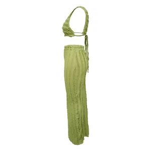 Side view of sage green two-piece set featuring textured lace fabric and tie-back top