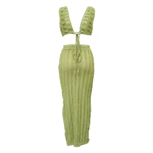 Detailed view of light green textured ruched two-piece skirt set with tie-up crop top