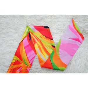 Close-up detail showing the vibrant abstract floral print on a fashion halter jumpsuit strap