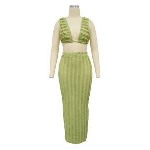 Detailed view of green textured two-piece sleeveless crop top and maxi skirt set