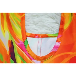 High-quality close-up of neckline stitching on a vibrant floral print halter neck romper