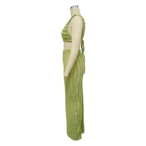 Side view of light green textured tripe lace two-piece set with backless crop top