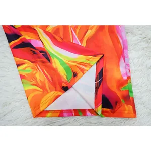 Close-up view of vibrant floral print jumpsuit showing high-quality stitching and fabric