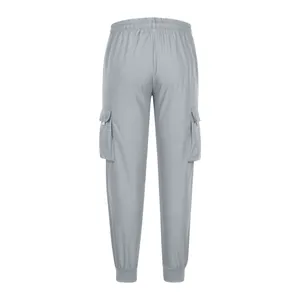 Back view of loose men's cargo pants in light gray featuring functional side pockets