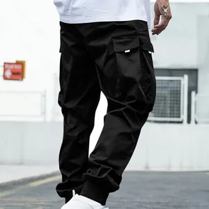 Back view of black multi-pocket cargo pants with white accents and cuffed ankles