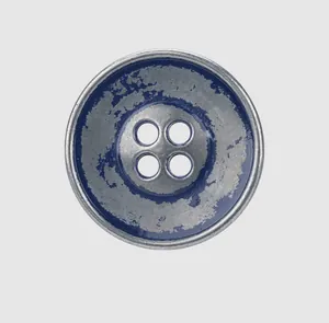 Close-up detail of a vintage style 4-hole metal button with distressed blue enamel finish