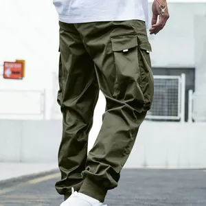Detailed view of men's olive green multi-pocket cargo pants with a loose streetwear jogger fit.