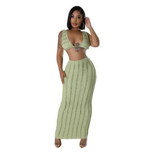 Close-up of olive green two-piece clothing set with textured lace top and long skirt