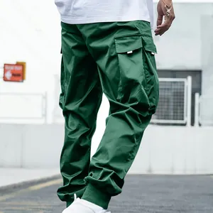 Back view of men's green cargo pants featuring multiple utility pockets and elastic cuffs