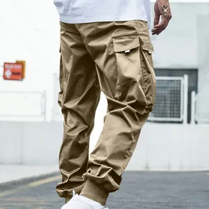 Detailed view of khaki cargo pants with multiple functional pockets and cuffed ankles.