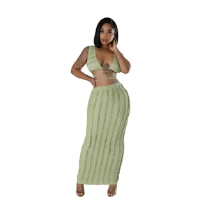Detailed view of sage green two-piece set featuring a textured crop top and maxi skirt