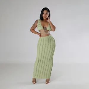 Elegant light green two-piece set featuring a tie-up crop top and textured maxi skirt.