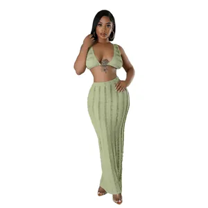 Detail showing the sage green textured lace fabric of the sleeveless two-piece set