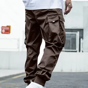 Close-up of multi-pocket brown cargo pants showing the fabric texture and loose fit.