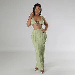 Elegant textured sage green two-piece set featuring a sleeveless crop top and maxi skirt